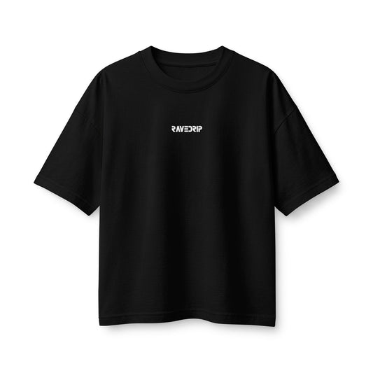 Front flat lay studio shot of the RAVEDRIP Core Matrix Boxy Tee in solid black, showcasing its heavyweight Airlume cotton fabric, double-stitched neckline, and centered micro-logo near the collar.