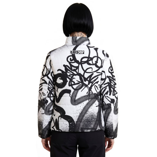 Back view of RAVEDRIP Padded Puffer Jacket featuring minimalist black and white logo block on the upper back, white insulated streetwear coat with chaotic black street art spray paint graphics, alternative female model with symmetrical black bob haircut.