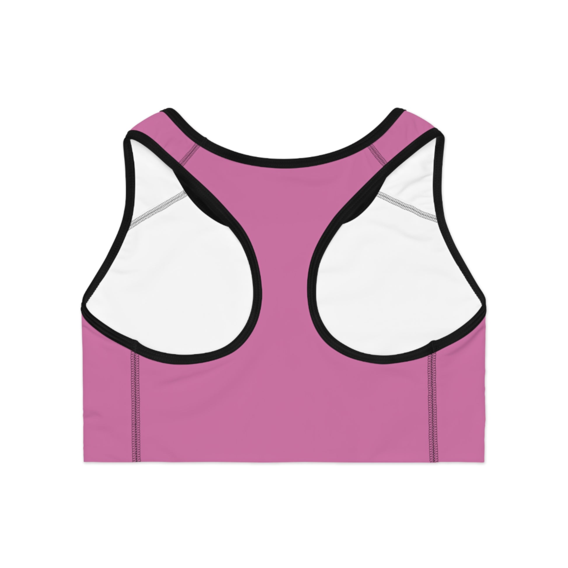 Back view of pink sports bra featuring racerback-style straps and a cheeky statement print in bold white font

