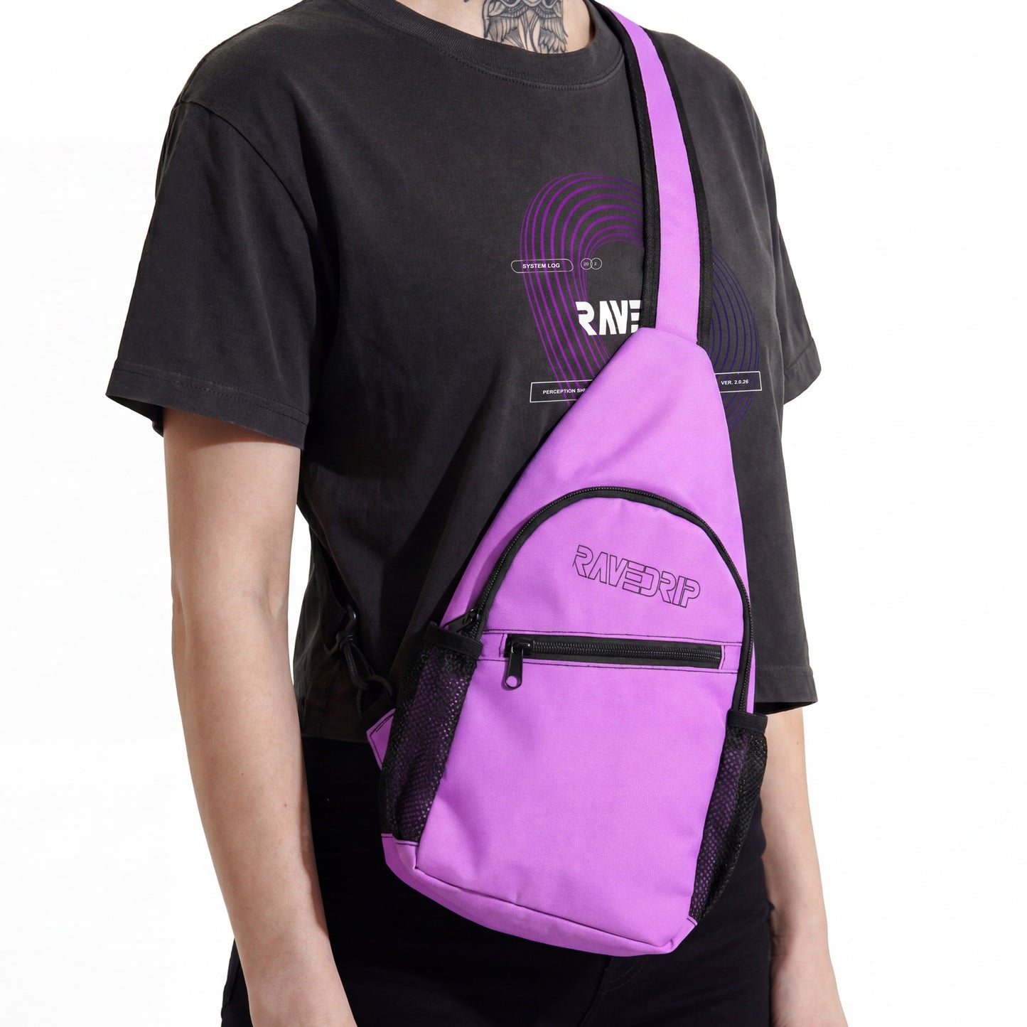 Close-up studio product shot from the neck down of a female model wearing a faded black cropped t-shirt with a purple vortex print and a RAVEDRIP purple canvas sling chest bag. The tactical teardrop-shaped bag is worn crossbody, showcasing its black zippers and the RAVEDRIP outline logo. Premium e-commerce techwear photography.