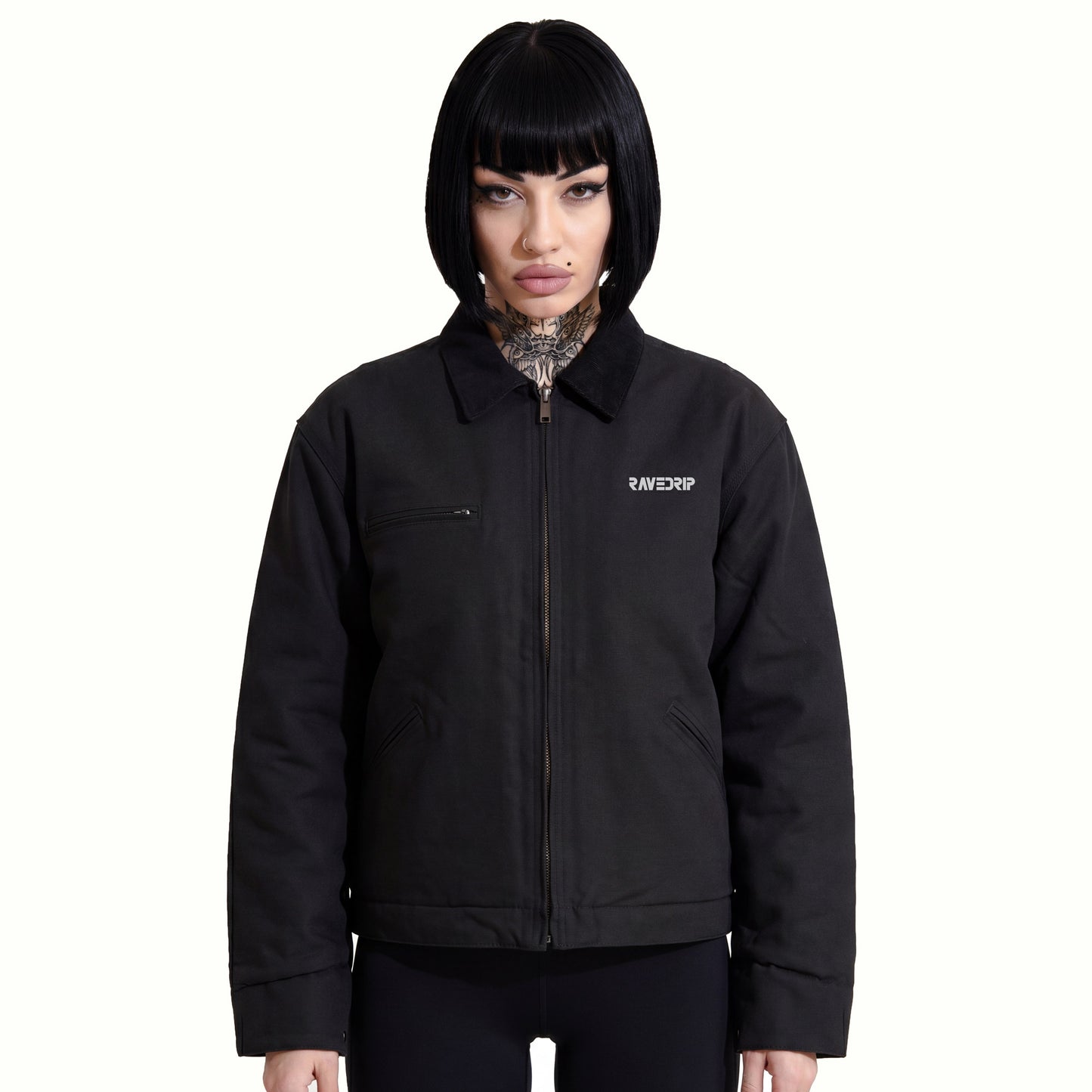 Front view of Marianna wearing the RAVEDRIP Blank Slate Structured Canvas Jacket, showcasing the rigid 12 oz black duck cloth drape, contrasting corduroy collar, and technical chest zipper against a minimal white backdrop.