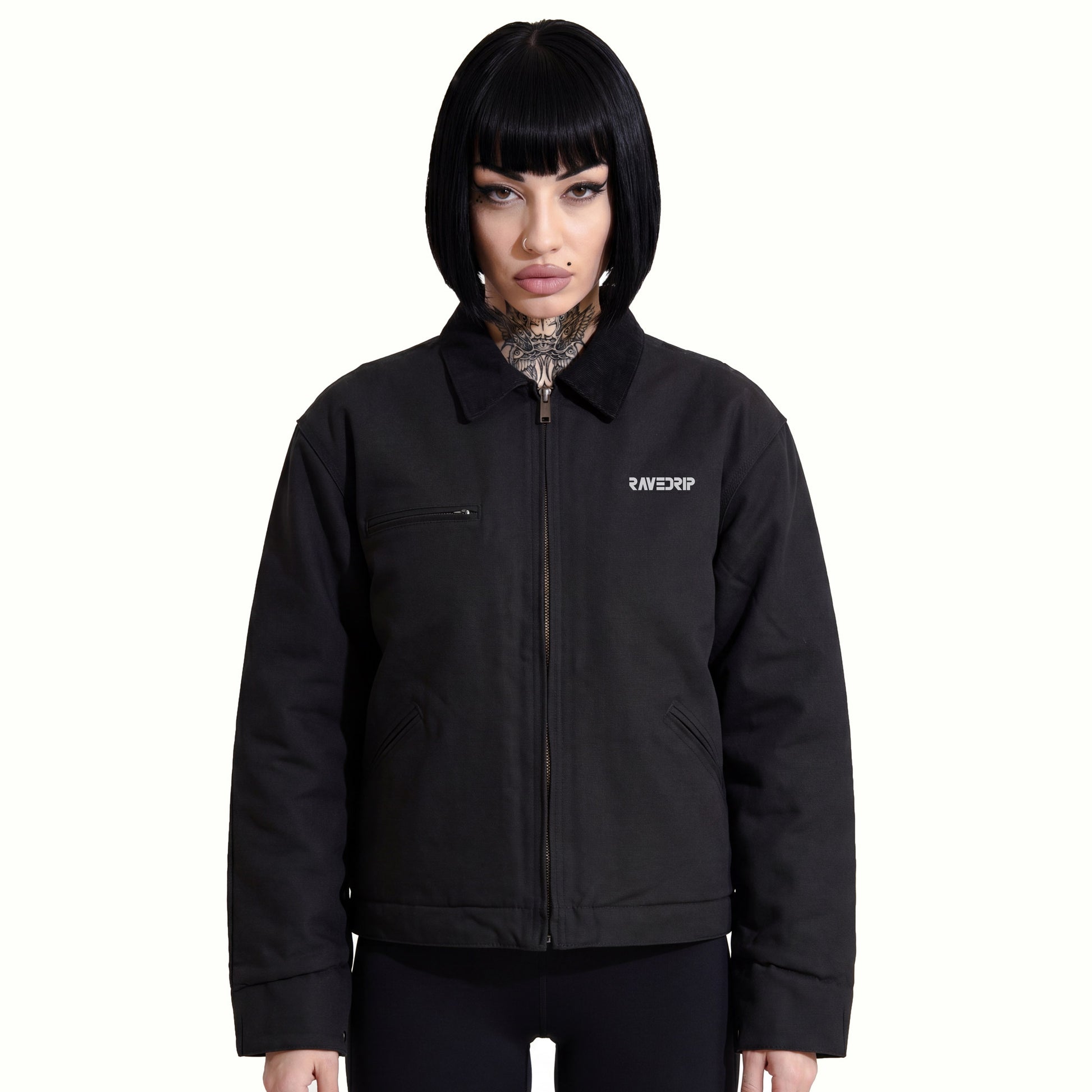 Front view of Marianna wearing the RAVEDRIP Blank Slate Structured Canvas Jacket, showcasing the rigid 12 oz black duck cloth drape, contrasting corduroy collar, and technical chest zipper against a minimal white backdrop.