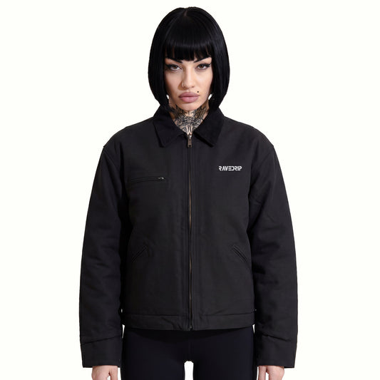 Front view of Marianna wearing the RAVEDRIP Blank Slate Structured Canvas Jacket, showcasing the rigid 12 oz black duck cloth drape, contrasting corduroy collar, and technical chest zipper against a minimal white backdrop.