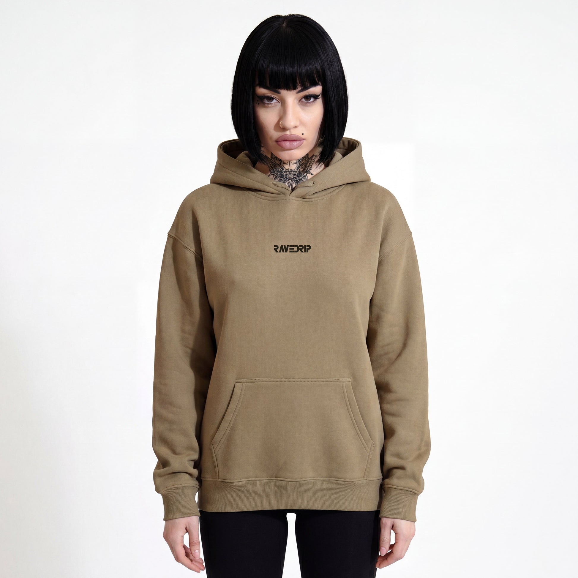 Front view of a woman wearing the RAVEDRIP Core Fleece Heavyweight Hoodie in earth-tone khaki brown, featuring an oversized fit with dropped shoulders and a clean neckline with tucked drawstrings.