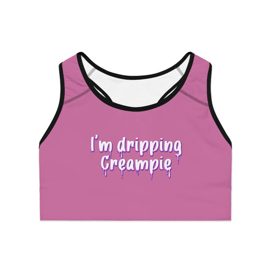 Front view of hot pink sports bra with bold "I’m Dripping Creampie" text, double-layer design, and vibrant all-over print

