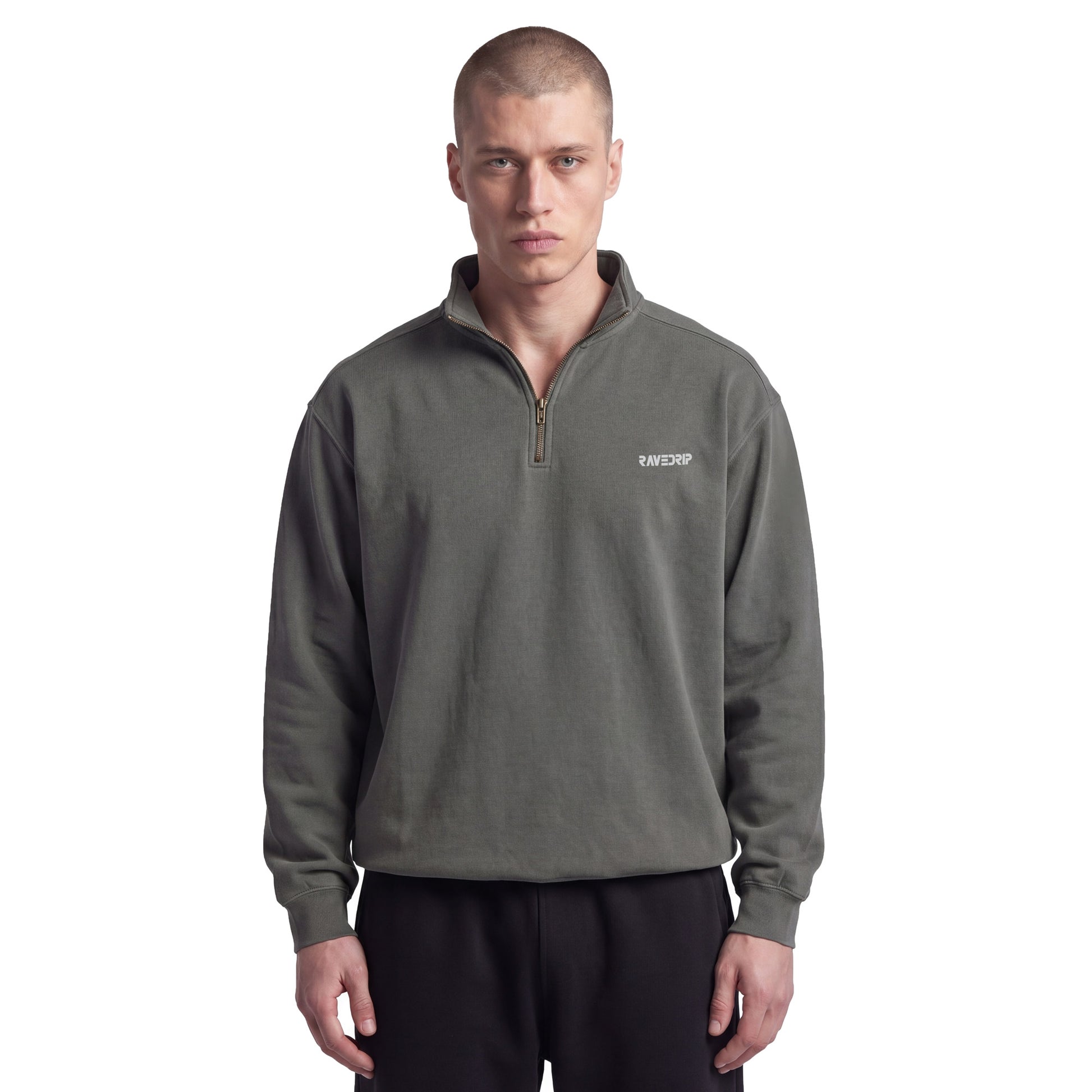 Male model with an edgy aesthetic styling the RAVEDRIP Sector 210 heavyweight quarter-zip sweatshirt in pepper charcoal with black sweatpants on a white studio background.