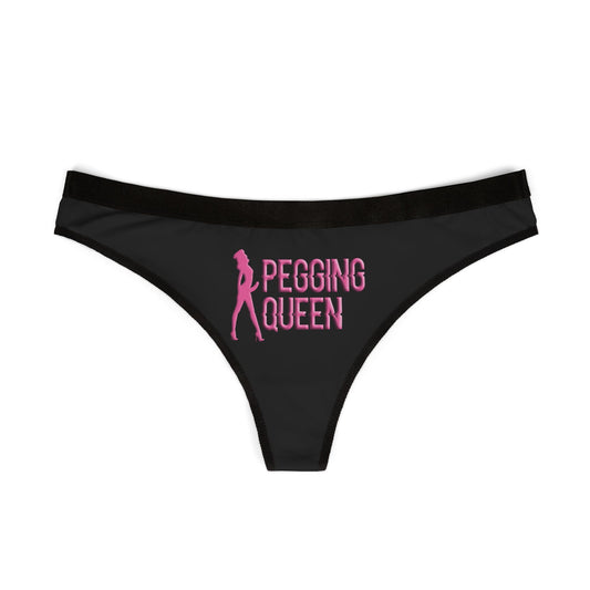 Pegging Queen women's thong laid flat – bold pink design with black waistband, edgy and flirty vibe.
