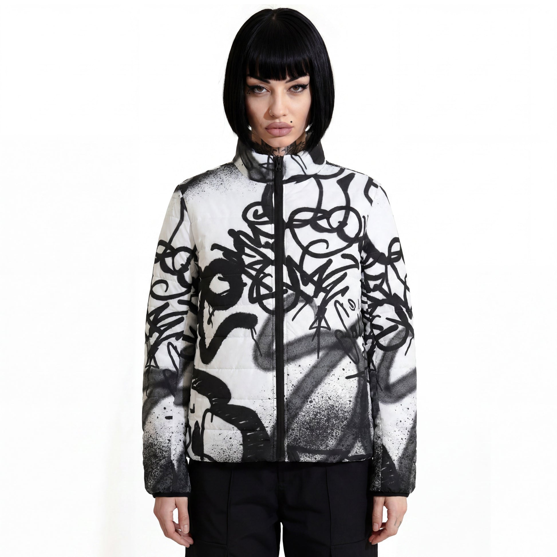 RAVEDRIP Womens Padded Puffer Jacket in white with high-contrast black graffiti spray paint all-over print and full-front nylon zipper, streetwear insulated outerwear worn by alternative female model.